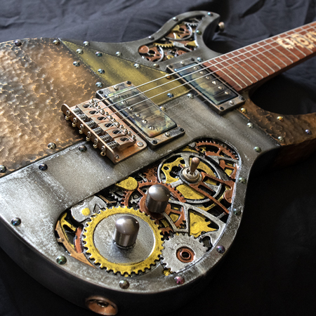 Silver copper and gold steampunk six string electric guitar with carved gears